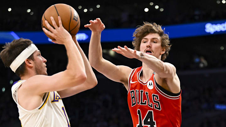 Mar 22, 2025; Los Angeles, California, USA; Chicago Bulls forward Matas Buzelis (14) attempts to block against Los Angeles Lakers guard Austin Reaves (15)