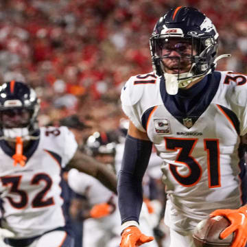 Oct 12, 2023; Kansas City, Missouri, USA; Denver Broncos safety Justin Simmons (31) celebrates after making an interception against the Kansas City Chiefs during the first half at GEHA Field at Arrowhead Stadium.