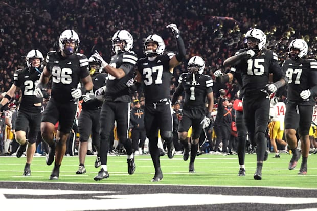 Nebraska players run to the end zone to celebrate Andrew Marshall's interception against USC.