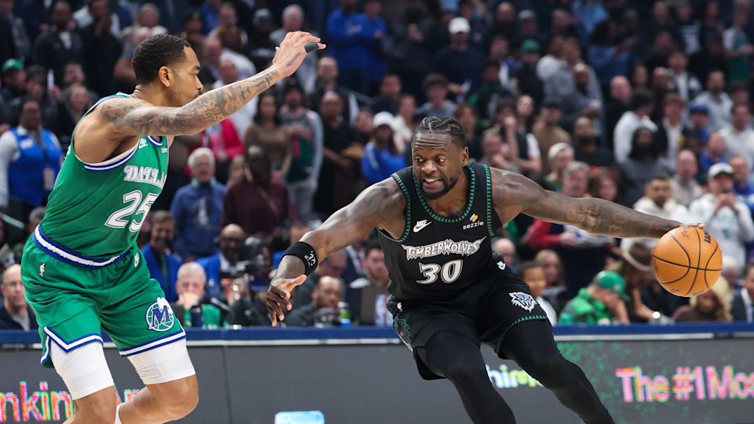 Jan 28, 2026; Dallas, Texas, USA;  Minnesota Timberwolves forward Julius Randle (30) drives to the basket as Dallas Mavericks forward P.J. Washington (25) defends during the first quarter at American Airlines Center. Mandatory Credit: Kevin Jairaj-Imagn Images