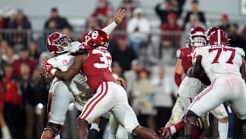 Oklahoma Sooners defensive lineman R Mason Thomas (32) hits Alabama Crimson Tide quarterback Jalen Milroe (4).