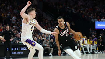 Portland Trail Blazers forward Kris Murray dribbles the ball past Los Angeles Lakers guard Dalton Knecht in the first half