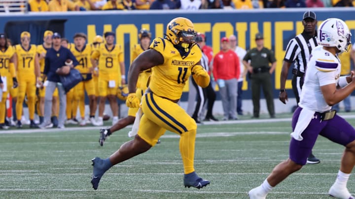 West Virginia University defensive lineman TJ Jackson chases down University at Albany quarterback Myles Burkett.