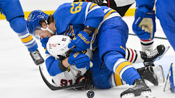 Oct 15, 2025; St. Louis, Missouri, USA; St. Louis Blues left wing Jake Neighbours (63) fights Chicago Blackhawks center Frank Nazar (91) after he scored and collided with goaltender Joel Hofer (not pictured) during the second period at Enterprise Center. Mandatory Credit: Jeff Curry-Imagn Images