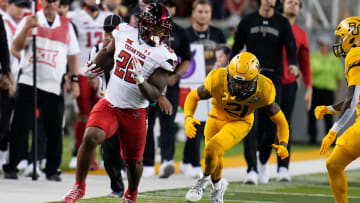 Oct 7, 2023; Waco, Texas, USA;  Texas Tech Red Raiders running back Bryson Donnell (22) runs the ball against Baylor Bears cornerback Chateau Reed (21) during the first half at McLane Stadium. Mandatory Credit: Chris Jones-USA TODAY Sports