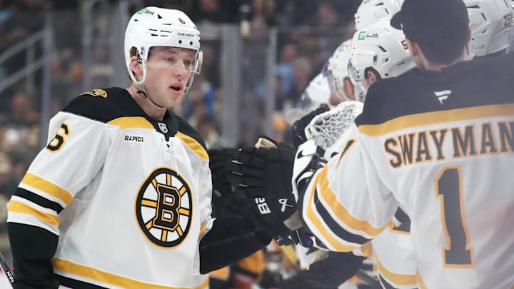 Boston Bruins defenseman Mason Lohrei celebrates with teammates after scoring a goal against the Pittsburgh Penguins.