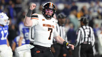 Oct 18, 2024; Provo, Utah, USA; Oklahoma State Cowboys quarterback Alan Bowman (7) celebrates a touchdown against the Brigham Young Cougars during the fourth quarter at LaVell Edwards Stadium. Mandatory Credit: Rob Gray-Imagn Images