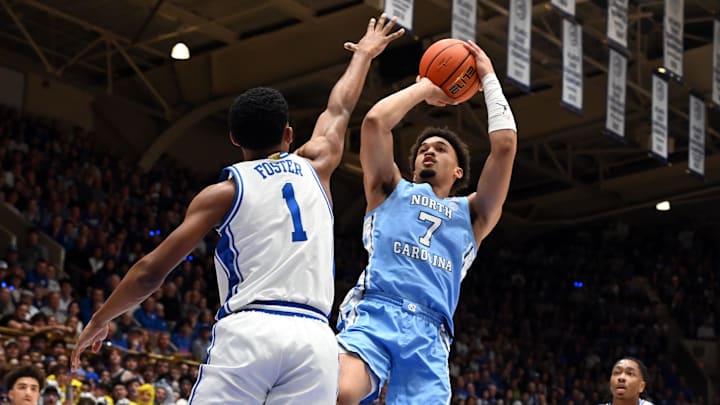 Mar 7, 2026; Durham, North Carolina, USA; North Carolina Tar Heels guard Seth Trimble (7) shoots over Duke Blue Devils guard Caleb Foster (1) during the first half at Cameron Indoor Stadium. Mandatory Credit: Rob Kinnan-Imagn Images