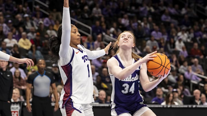 Mar 7, 2026; Kansas City, MO, USA;  Kansas State Wildcats guard Tess Heal (34) goes in for a layup against TCU Horned Frogs guard Taylor Bigby (1) during the first half at T-Mobile Center.