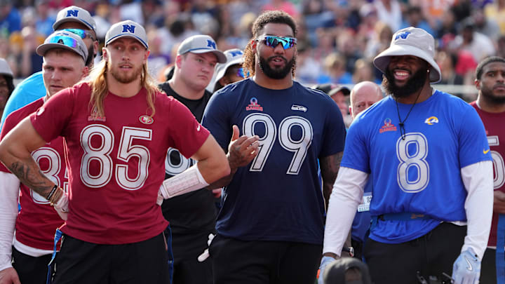 Feb 2, 2025; Orlando, FL, USA; NFC tight end George Kittle of the San Francisco 49ers (85), defensive end Leonard Williams of the Seattle Seahawks (99) and linebacker Jared Verse of the Los Angeles Rams (8) watch during the 2025 Pro Bowl Games at Camping World Stadium.