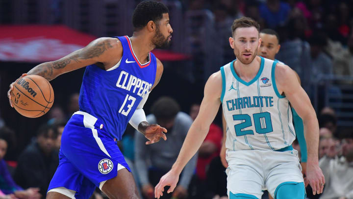 Dec 26, 2023; Los Angeles, California, USA; Los Angeles Clippers forward Paul George (13) moves the ball against Charlotte Hornets forward Gordon Hayward (20) during the first half at Crypto.com Arena. Mandatory Credit: Gary A. Vasquez-USA TODAY Sports