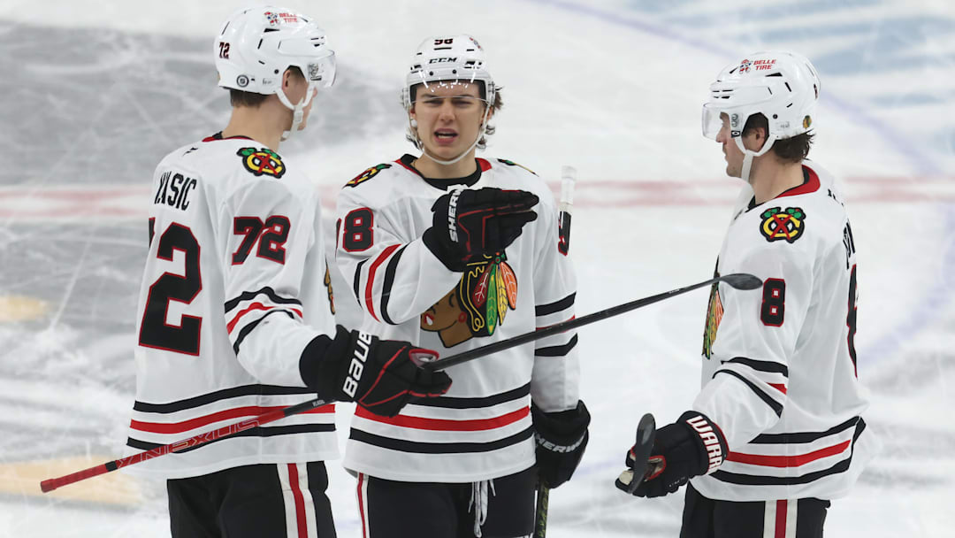 Apr 8, 2025; Pittsburgh, Pennsylvania, USA;  Chicago Blackhawks defenseman Alex Vlasic (72) and center Connor Bedard (98) and center Ryan Donato (8) talk on the ice against the Pittsburgh Penguins during the second period at PPG Paints Arena. Mandatory Credit: Charles LeClaire-Imagn Images