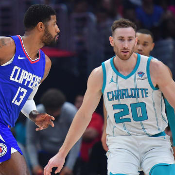 Dec 26, 2023; Los Angeles, California, USA; Los Angeles Clippers forward Paul George (13) moves the ball against Charlotte Hornets forward Gordon Hayward (20) during the first half at Crypto.com Arena. Mandatory Credit: Gary A. Vasquez-USA TODAY Sports