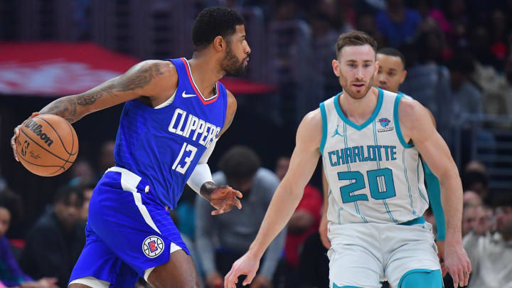 Dec 26, 2023; Los Angeles, California, USA; Los Angeles Clippers forward Paul George (13) moves the ball against Charlotte Hornets forward Gordon Hayward (20) during the first half at Crypto.com Arena. Mandatory Credit: Gary A. Vasquez-USA TODAY Sports