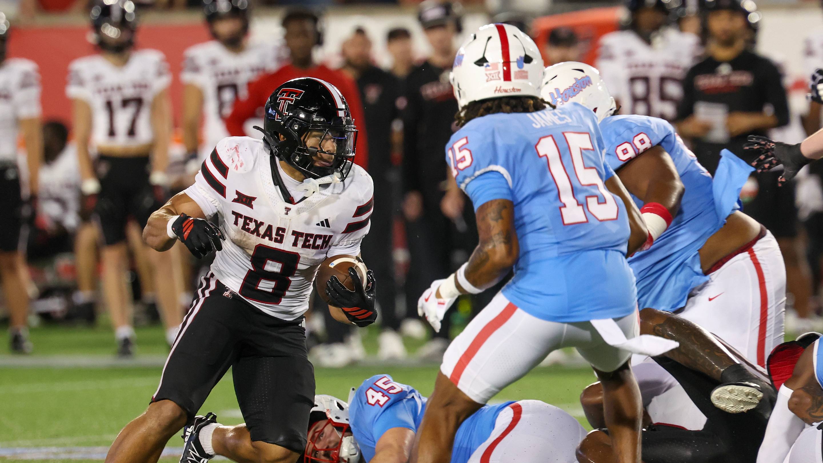 Oct 4, 2025; Houston, Texas, USA; Texas Tech Red Raiders running back Cameron Dickey (8) rushes against Houston Cougars defensive back Will James (15) in the second half at TDECU Stadium. Mandatory Credit: Thomas Shea-Imagn Images | IMAGN IMAGES via Reuters Connect