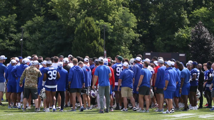 Bills owners Terry Pegula and wife Kim Pegula are surrounded in the team huddle at the end of day three of the Buffalo Bills training camp.