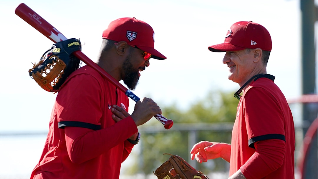 Cincinnati Reds special assistant Barry Larkin, left, shares a laugh with manager David Bell