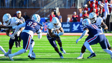 Nov 11, 2023; Lynchburg, Virginia, USA;  Old Dominion Monarchs running back Obie Sanni (21) runs the ball while being pursued by Liberty Flames defensive tackle Chris Boti (92) and Liberty Flames defensive end CJ Bazile Jr. (11) at Williams Stadium. Mandatory Credit: Brian Bishop-USA TODAY Sports