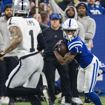 Dec 31, 2023; Indianapolis, Indiana, USA; Indianapolis Colts wide receiver Josh Downs (1) runs with the ball after the catch while Las Vegas Raiders safety Marcus Epps (1) defends in the first quarter at Lucas Oil Stadium. Mandatory Credit: Trevor Ruszkowski-Imagn Images