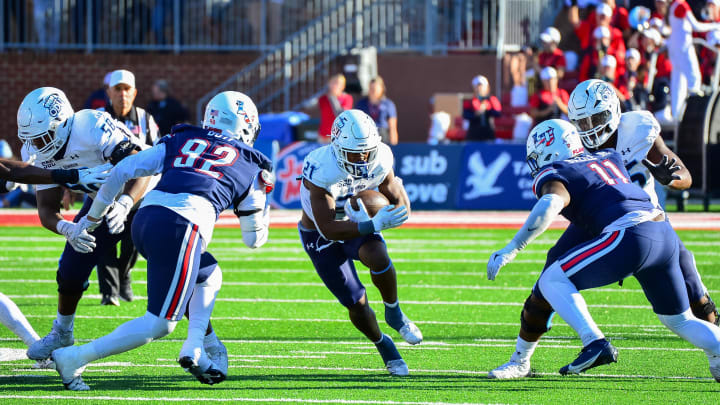 Nov 11, 2023; Lynchburg, Virginia, USA;  Old Dominion Monarchs running back Obie Sanni (21) runs the ball while being pursued by Liberty Flames defensive tackle Chris Boti (92) and Liberty Flames defensive end CJ Bazile Jr. (11) at Williams Stadium. Mandatory Credit: Brian Bishop-USA TODAY Sports