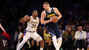 Nov 23, 2024; Los Angeles, California, USA;  Denver Nuggets center Nikola Jokic (15) posts up against Los Angeles Lakers forward Rui Hachimura (28) during the fourth quarter at Crypto.com Arena. Mandatory Credit: Kiyoshi Mio-Imagn Images