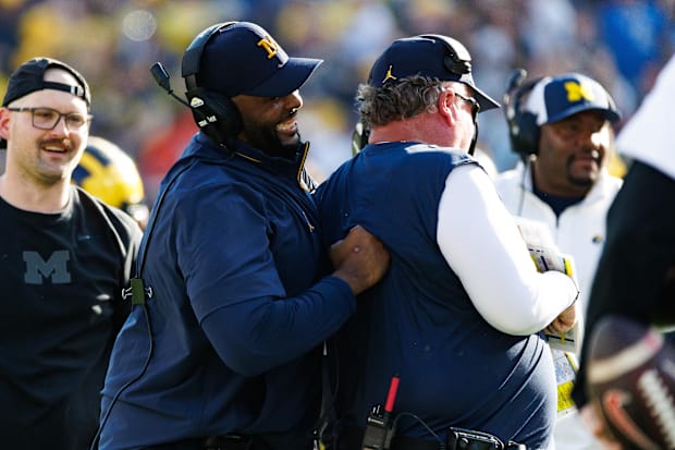 Michigan Football head coach Sherrone Moore celebrates with defensive coordinator Wink Martindale