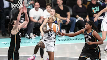 Oct 10, 2024; Brooklyn, New York, USA; Minnesota Lynx guard Courtney Williams (10) drives in between New York Liberty forwards Breanna Stewart (30) and Jonquel Jones (35) in overtime at Barclays Center. Mandatory Credit: Wendell Cruz-Imagn Images