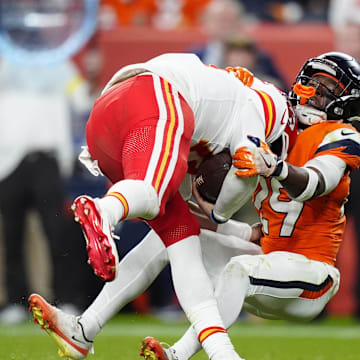 Nov 16, 2025; Denver, Colorado, USA; Denver Broncos cornerback Ja'Quan McMillian (29) sacks Kansas City Chiefs quarterback Patrick Mahomes (15) in the fourth quarter at Empower Field at Mile High. Mandatory Credit: Ron Chenoy-Imagn Images