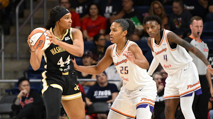 Sep 4, 2025; Washington, District of Columbia, USA;  Washington Mystics forward Kiki Iriafen (44) looks to pass in front of Phoenix Mercury forward Alyssa Thomas (25) during the first quarter at CareFirst Arena. Mandatory Credit: Rafael Suanes-Imagn Images
