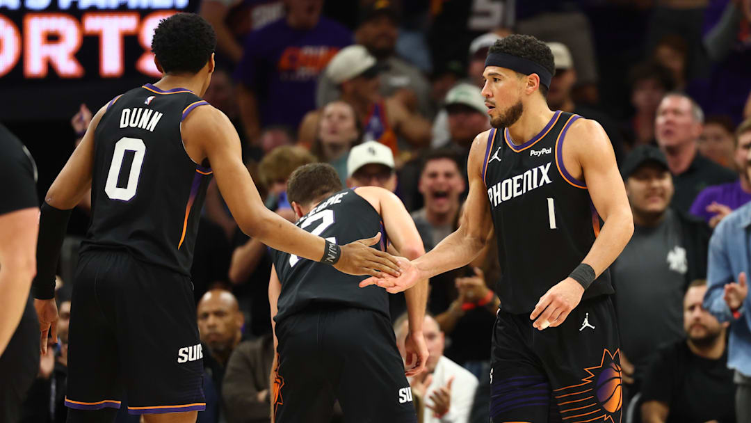Apr 14, 2026; Phoenix, Arizona, USA; Phoenix Suns guard Devin Booker (1) celebrates with Ryan Dunn (0) against the Portland Trail Blazers in the second half during the play-in rounds of the 2026 NBA Playoffs at Mortgage Matchup Center. Mandatory Credit: Mark J. Rebilas-Imagn Images