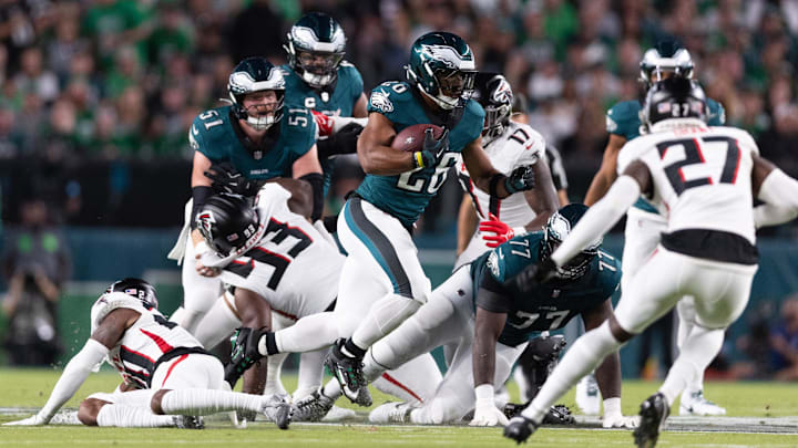 Sep 16, 2024; Philadelphia, Pennsylvania, USA; Philadelphia Eagles running back Saquon Barkley (26) runs with the ball against the Atlanta Falcons during the first quarter at Lincoln Financial Field.  