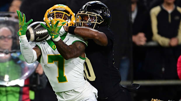 Oregon Ducks wide receiver Evan Stewart (7) catches a long pass under coverage from Purdue Boilermakers defensive back Kyndri
