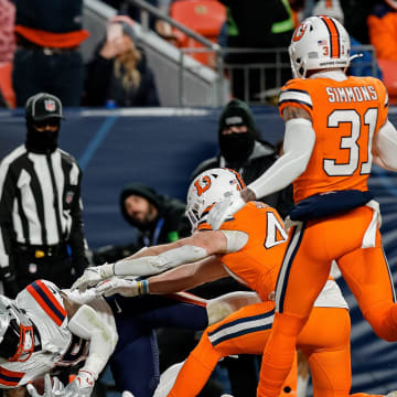 Dec 24, 2023; Denver, Colorado, USA; New England Patriots running back Ezekiel Elliott (15) dives for a touchdown against Denver Broncos linebacker Josey Jewell (47) and safety Justin Simmons (31) in the third quarter at Empower Field at Mile High. Mandatory Credit: Isaiah J. Downing-USA TODAY Sports