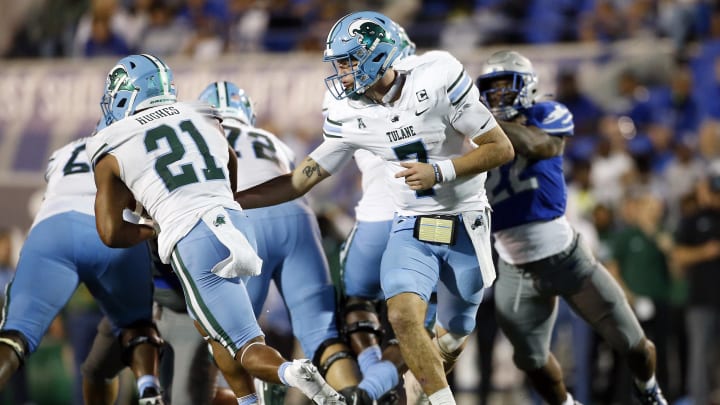 Oct 13, 2023; Memphis, Tennessee, USA; Tulane Green Wave quarterback Michael Pratt (7) hands the ball off to running back Makhi Hughes (21) during the second half against the Memphis Tigers at Simmons Bank Liberty Stadium. Mandatory Credit: 