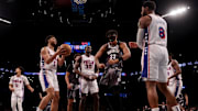 Feb 12, 2025; Brooklyn, New York, USA; Brooklyn Nets center Nic Claxton (33) reacts after a basket against Philadelphia 76ers guard Quentin Grimes (5) and center Adem Bona (30) and forward Paul George (8) during the third quarter at Barclays Center. Mandatory Credit: Brad Penner-Imagn Images