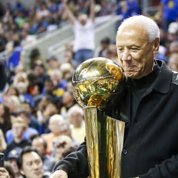 Oct 5, 2018; Seattle, WA, USA; Former Seattle Supersonics head coach Lenny Wilkens holds the 1979 championship trophy during a third quarter timeout of a game between the Sacramento Kings and Golden State Warriors at KeyArena. Mandatory Credit: Joe Nicholson-Imagn Images