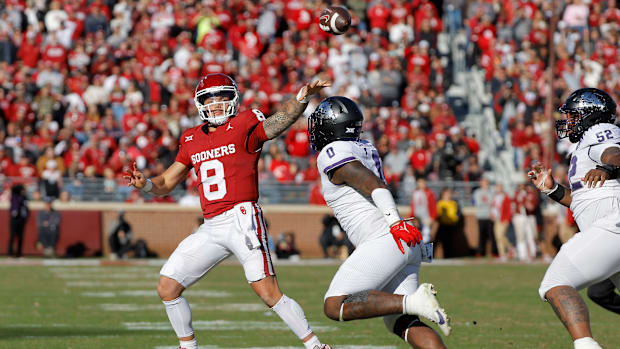 Oklahoma Sooners quarterback Dillon Gabriel (8) throws a pass over TCU Horned Frogs linebacker Shad Banks Jr. (0) during a co