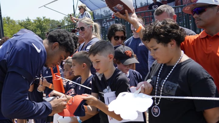 Wide receiver Tyler Scott signs autographs at Bears training camp. 