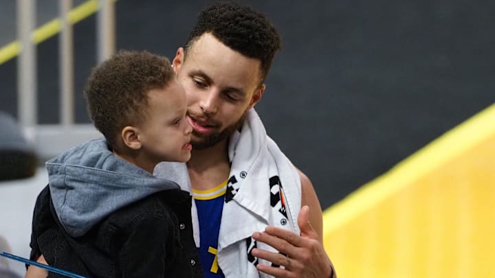 Golden State Warriors guard Stephen Curry (30) with his son Canon Curry after the game against the Utah Jazz at Chase Center.