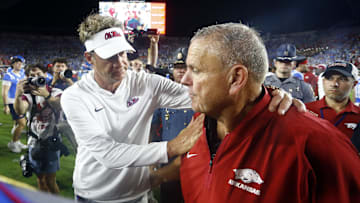 Sep 13, 2025; Oxford, Mississippi, USA; Mississippi Rebels head coach Lane Kiffin (left) and Arkansas Razorback head coach Sam Pittman (right) embrace after the game  at Vaught-Hemingway Stadium. Mandatory Credit: Petre Thomas-Imagn Images