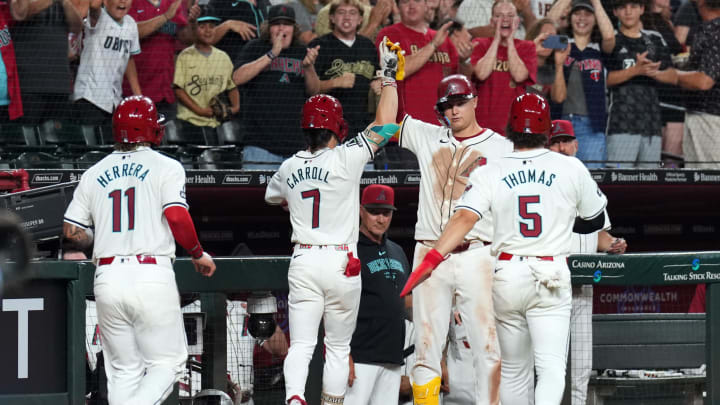 Jul 13, 2024; Phoenix, Arizona, USA; Arizona Diamondbacks outfielder Corbin Carroll (7) celebrates with teammates after hitting a three run home run against the Toronto Blue Jays during the seventh inning at Chase Field. Mandatory Credit: Joe Camporeale-USA TODAY Sports