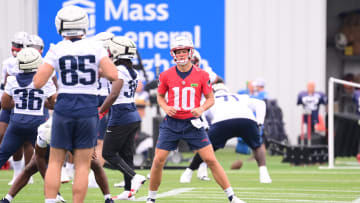 Jul 24, 2024; Foxborough, MA, USA;  New England Patriots quarterback Drake Maye (10) stretches during training camp at Gillette Stadium. Mandatory Credit: Eric Canha-USA TODAY Sports