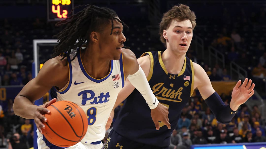 Feb 21, 2026; Pittsburgh, Pennsylvania, USA;  Pittsburgh Panthers guard Omari Witherspoon (8) drives to the basket  against Notre Dame Fighting Irish guard Cole Certa (right) during the first half at the Petersen Events Center. Mandatory Credit: Charles LeClaire-Imagn Images