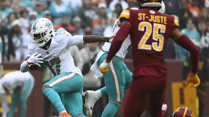 Dec 3, 2023; Landover, Maryland, USA; Miami Dolphins wide receiver Jaylen Waddle (17) runs after a catch against the Washington Commanders during the first half at FedExField. Mandatory Credit: Brad Mills-USA TODAY Sports