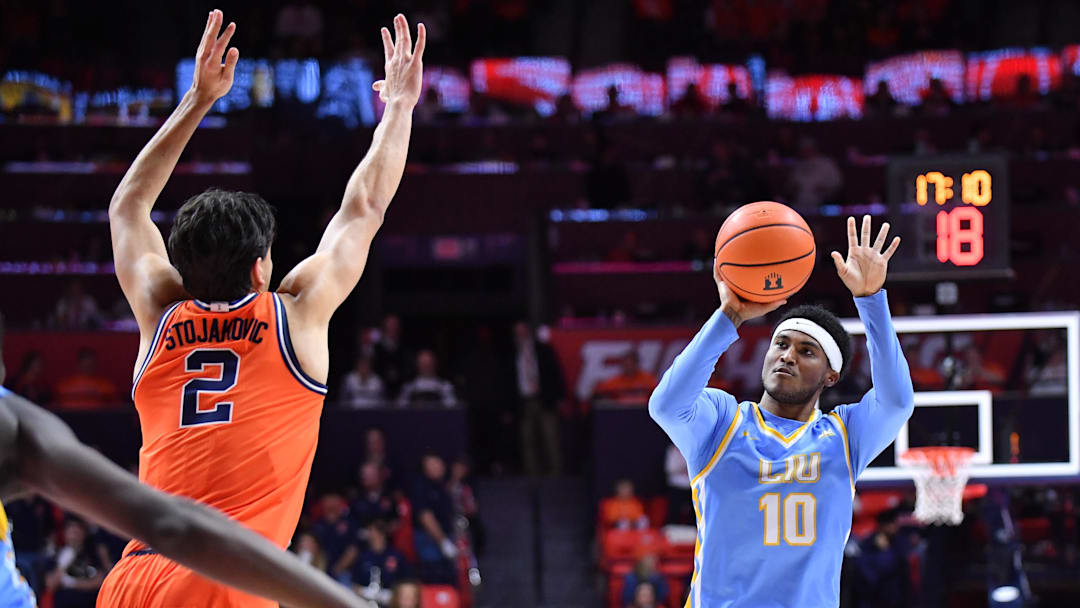 Nov 22, 2025; Champaign, Illinois, USA;  Long Island University Sharks guard A.J. Neal, Jr. (10) shoots the ball over Illinois Fighting Illini guard Andrej Stojakovic (2) during the second half at State Farm Center. Mandatory Credit: Ron Johnson-Imagn Images