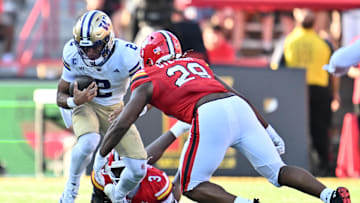 Oct 4, 2025; College Park, Maryland, USA;  Washington Huskies quarterback Demond Williams Jr. (2) is sacked by Maryland Terrapins linebacker Trey Reddick (3) and defensive lineman Sidney Stewart (29) in the first half at SECU Stadium. Mandatory Credit: Jamie Sabau-Imagn Images