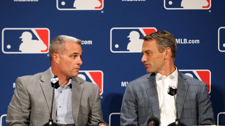 Dec 7, 2016; National Harbor, MD, USA; Kansas City Royals general manager Dayton Moore (L) talks with Chicago Cubs general manager Jed Hoyer (R) prior to speaking with the media after announcing a trade of relief pitcher Wade Davis for outfielder Jorge Soler (both not pictured) on day three of the 2016 Baseball Winter Meetings at Gaylord National Resort & Convention Center.
