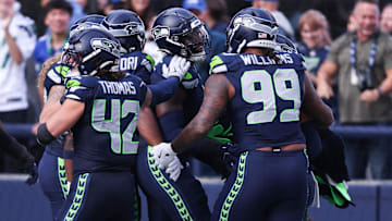 Nov 9, 2025; Seattle, Washington, USA; Seattle Seahawks defensive end DeMarcus Lawrence (0) celebrates with Seattle Seahawks defensive end Leonard Williams (99) and Seattle Seahawks linebacker Drake Thomas (42) after recovering a fumble to score a touchdown during the second quarter against the Arizona Cardinals at Lumen Field. Mandatory Credit: Kevin Ng-Imagn Images