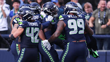 Seattle Seahawks defensive end DeMarcus Lawrence (middle) celebrates with teammates. 