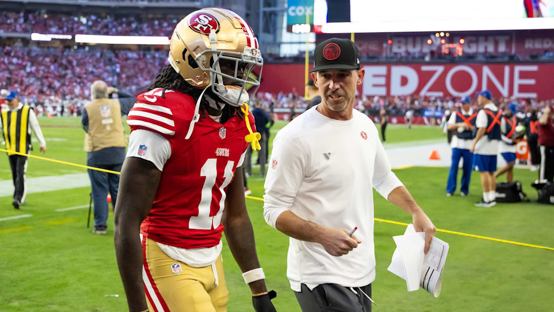 Dec 17, 2023; Glendale, Arizona, USA; San Francisco 49ers head coach Kyle Shanahan talks to wide receiver Brandon Aiyuk (11) against the Arizona Cardinals at State Farm Stadium. Mandatory Credit: Mark J. Rebilas-USA TODAY Sports